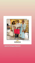 Customer review post featuring a photo of three women standing together in an indoor boutique setting. The central woman holds a bright pink shopping bag.