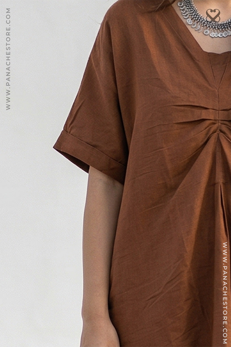Brown dress with a knot detail on a white background