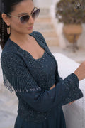 Woman wearing a designer deep peacock teal heavy embellished top with matching skirt