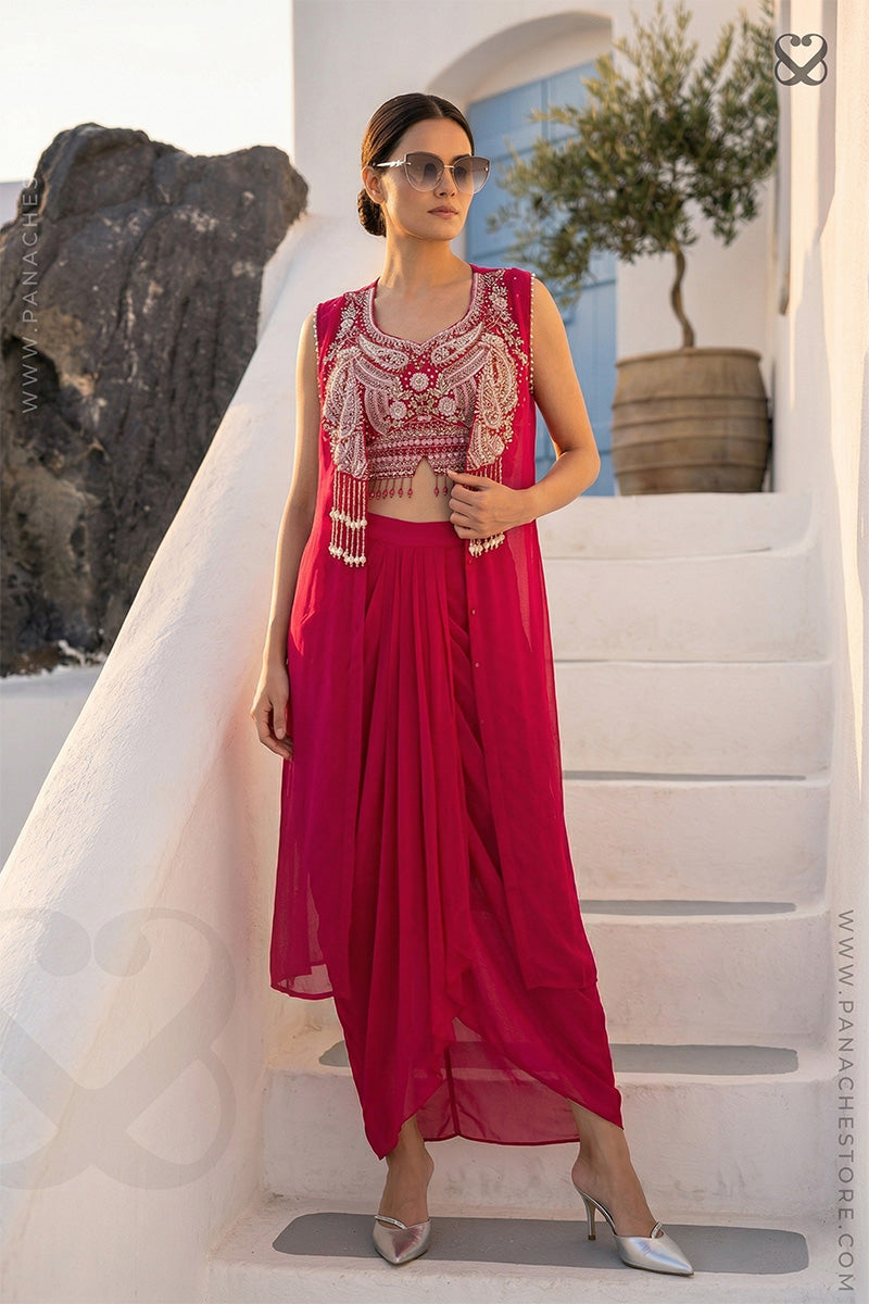 Woman in a Red heavy embroidered crop top blouse and shrug with matching skirt standing on steps