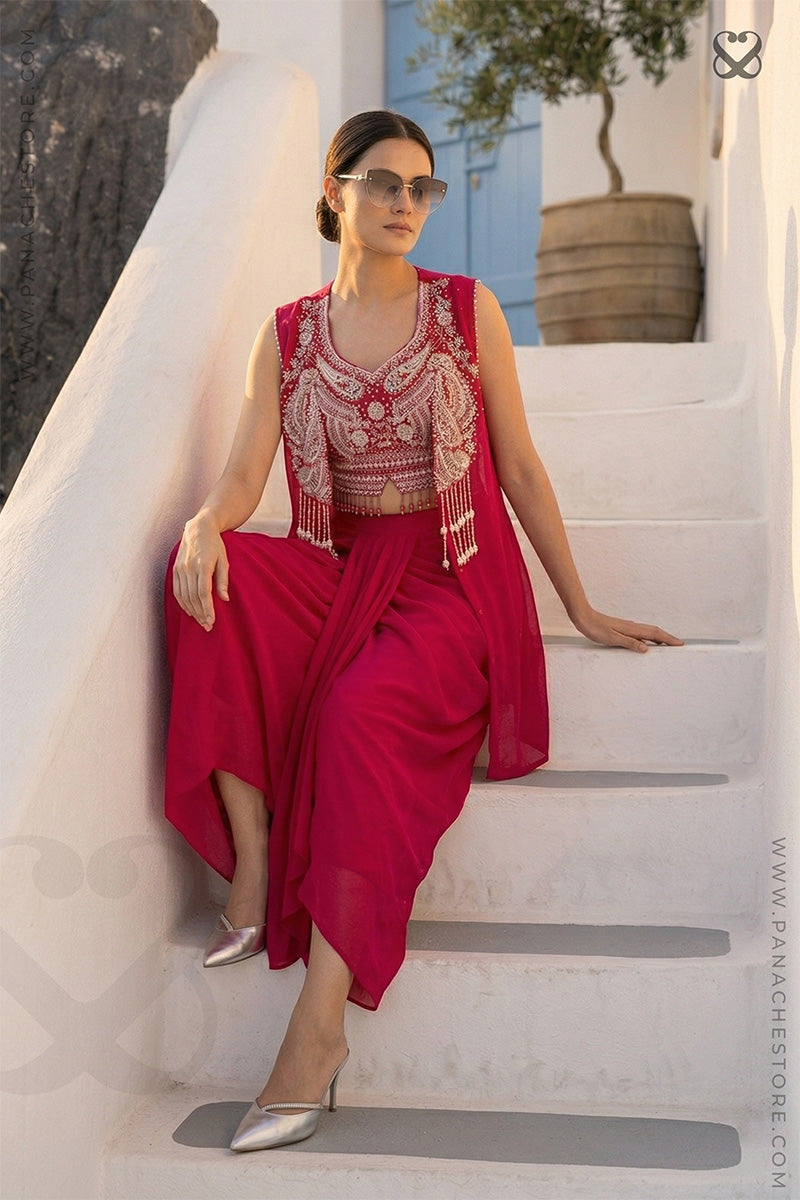 Woman in a Red and white heavy embroidered crop top blouse and shrug with matching skirt branding Panache Premium designer Lehenga Store