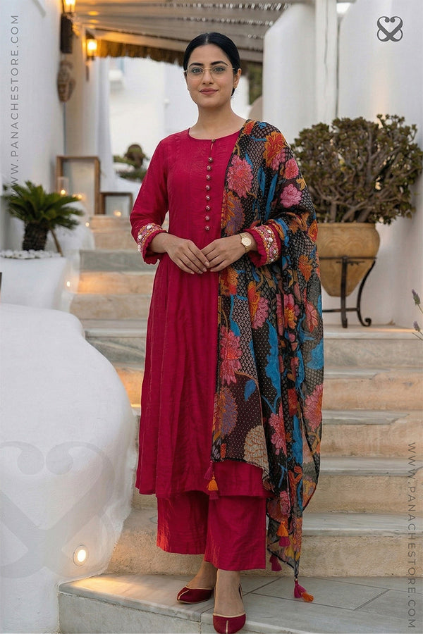 Woman in a red-pink kurti outfit with sequin embellishments on sleeves and floral print dupatta