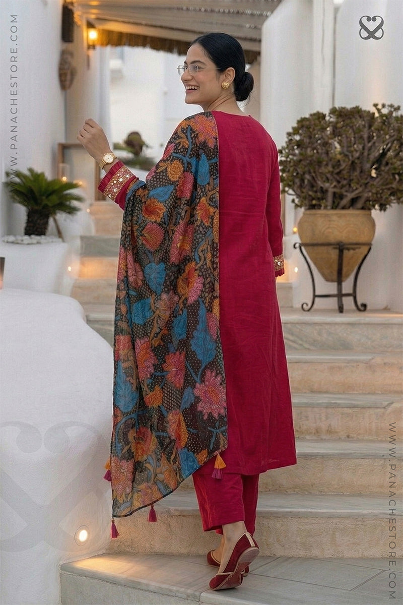 Woman in a red-pink kurti outfit with sequin embellishments on sleeves and floral print dupatta