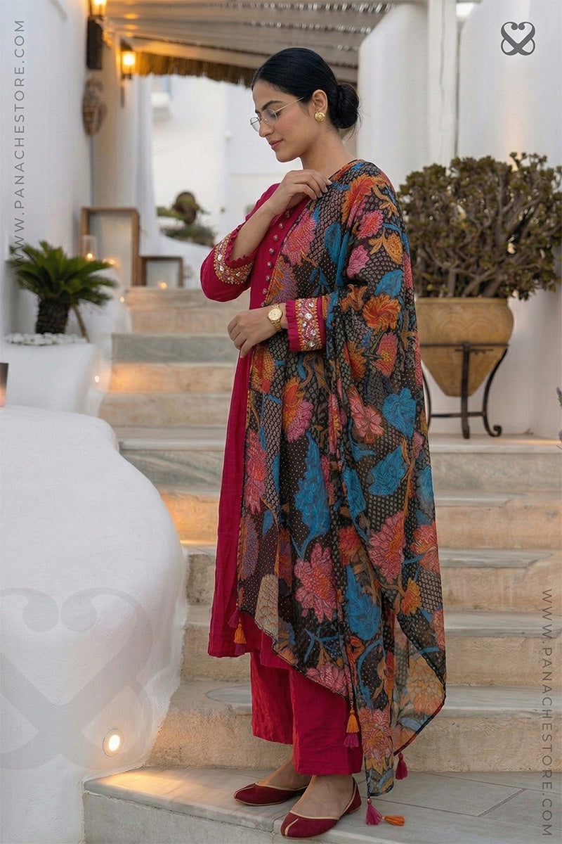 Woman in a red-pink kurti outfit with sequin embellishments on sleeves and floral print dupatta