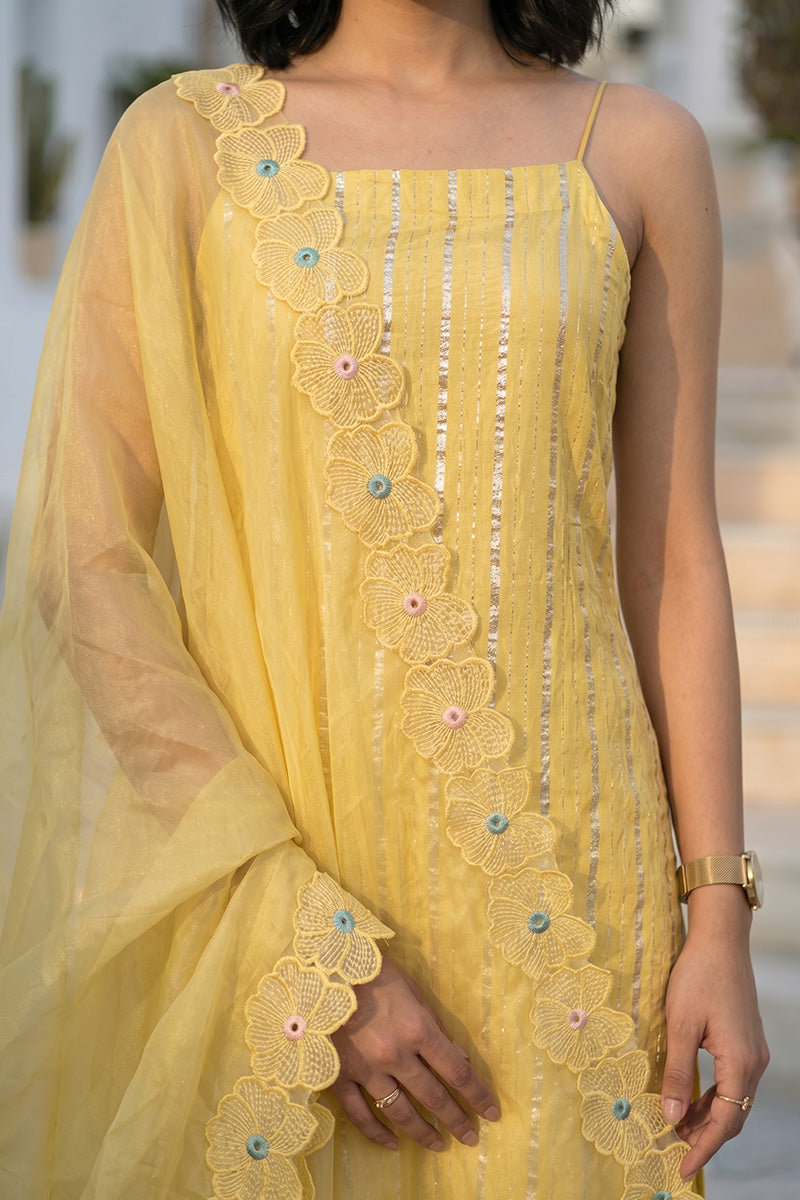 women in a yellow zari woven sleeveless kurti top with embroidered cutwork dupatta