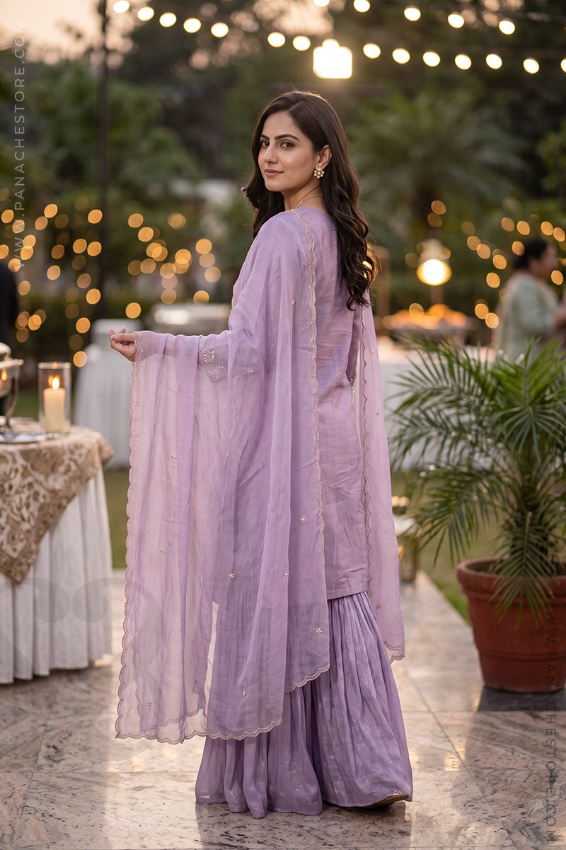 Back Pose: A woman wearing a lavender purple suit set in a wedding ceremoney