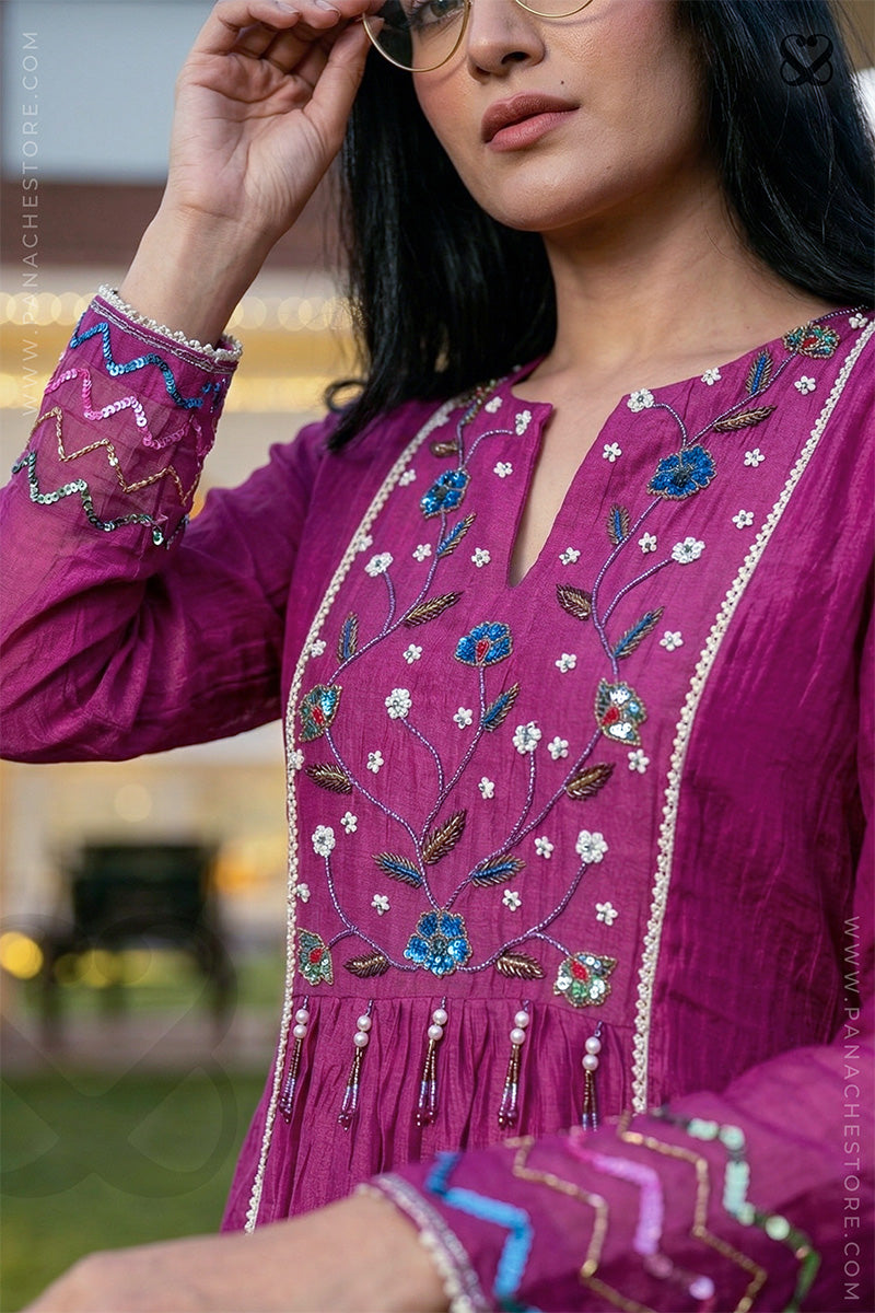 closeup shot of a women in magenta pink kurti with floral cutwork and sequin embellishments 