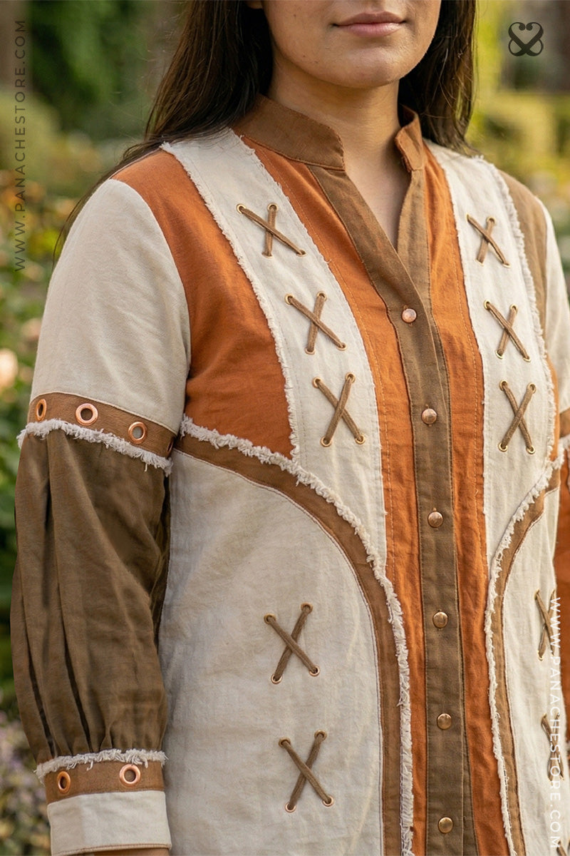 Close-up of a person wearing a traditional outfit with intricate designs and patterns.