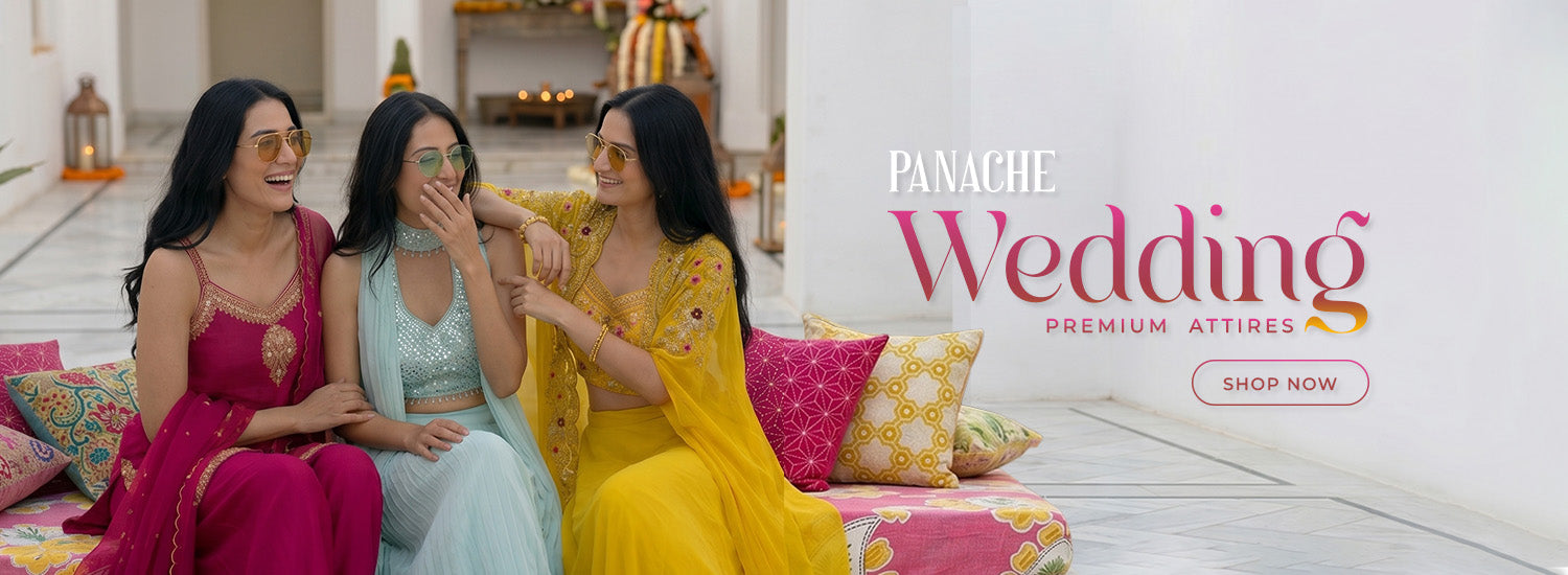 Three women in colorful designer wedding outfits sitting on a couch with 'Panache Wedding' advertisement.