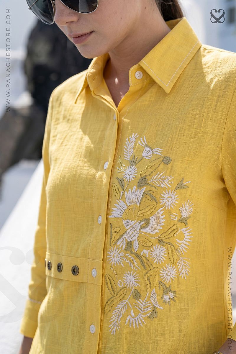 Yellow embroidered shirt worn by a girl with a blurred background